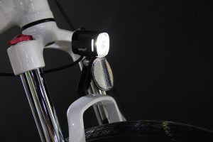 Fork mount e-bike light with reflector